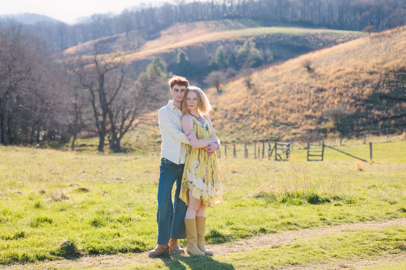 Appalachian State senior sitting in grassy field with mountain backdrop in Boone NC
